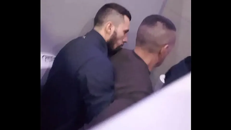 2 men having fun in a public toilet