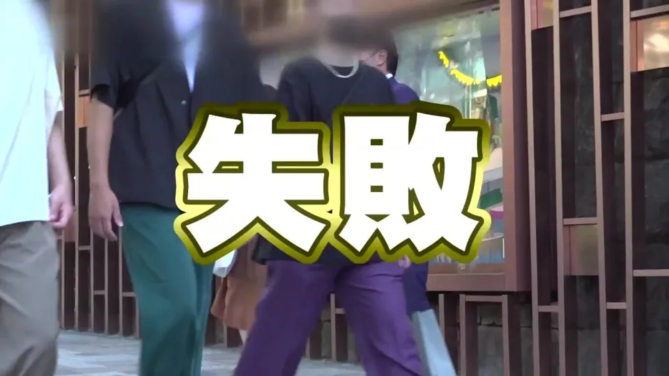 Two men stroll past storefronts in urban setting