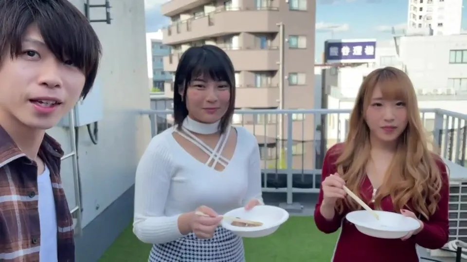 Asian trio enjoys rooftop meal with chopsticks