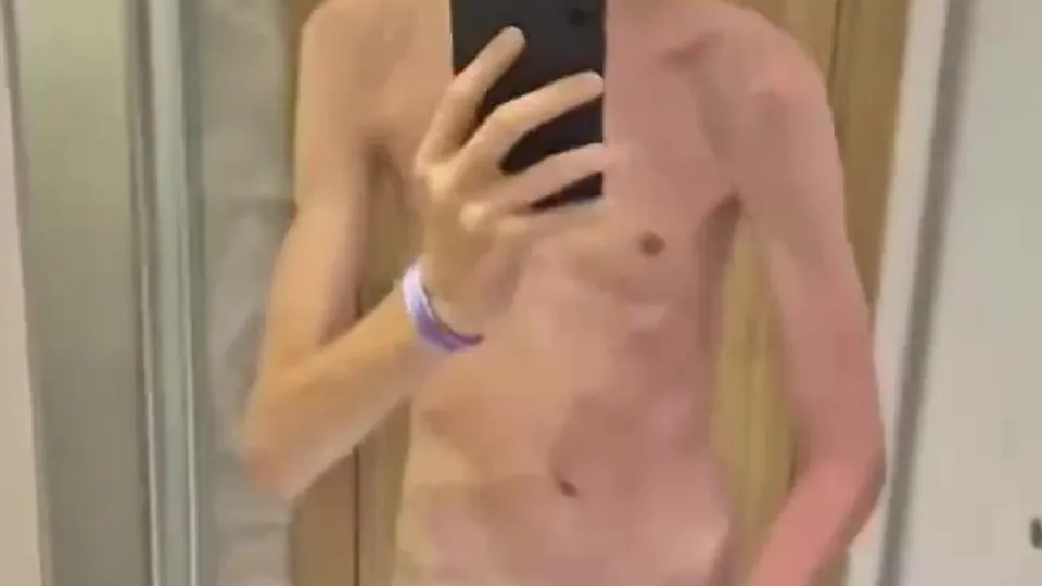 A skinny white twink shows off his big uncut dick
