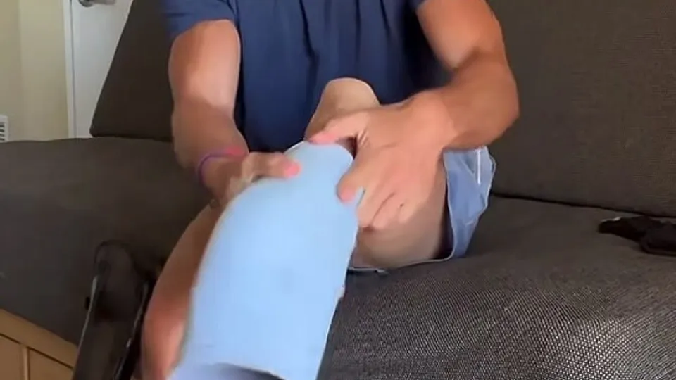 Solo man plays with blue cylinder on couch
