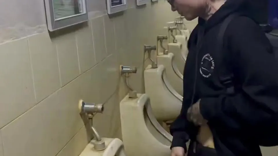 Asian pissing in a urinal