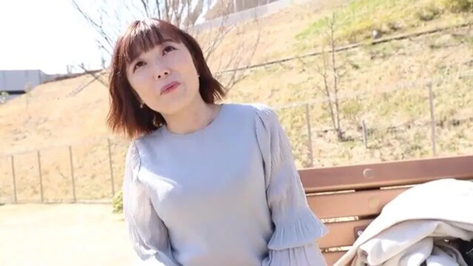 asian woman gazes upward outdoors
