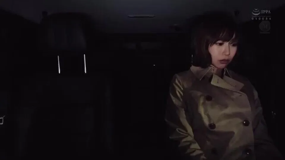 asian woman in trench coat inside car