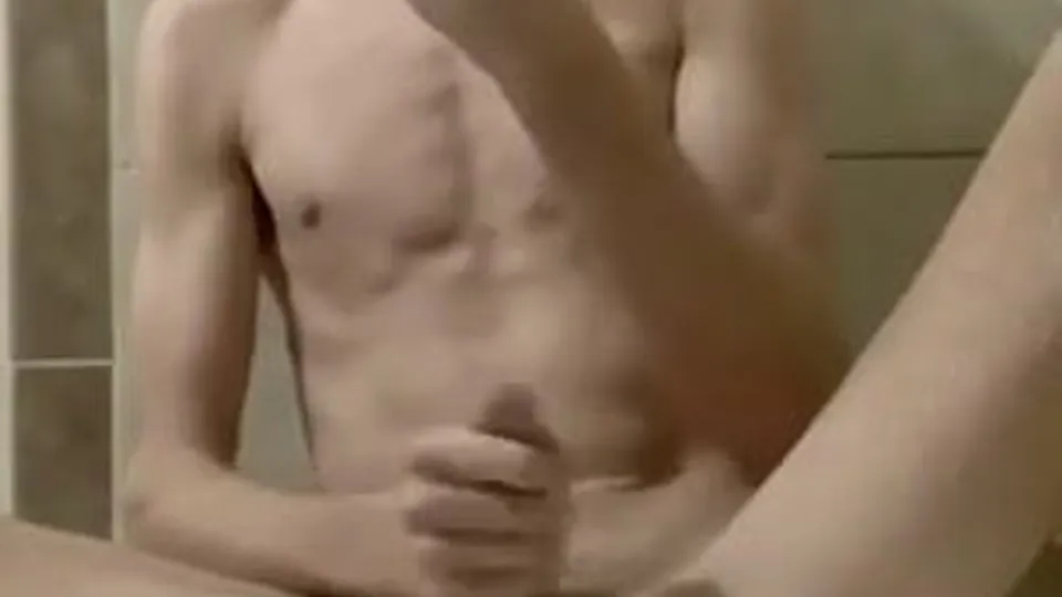 Cumming to porn on his mobile phone