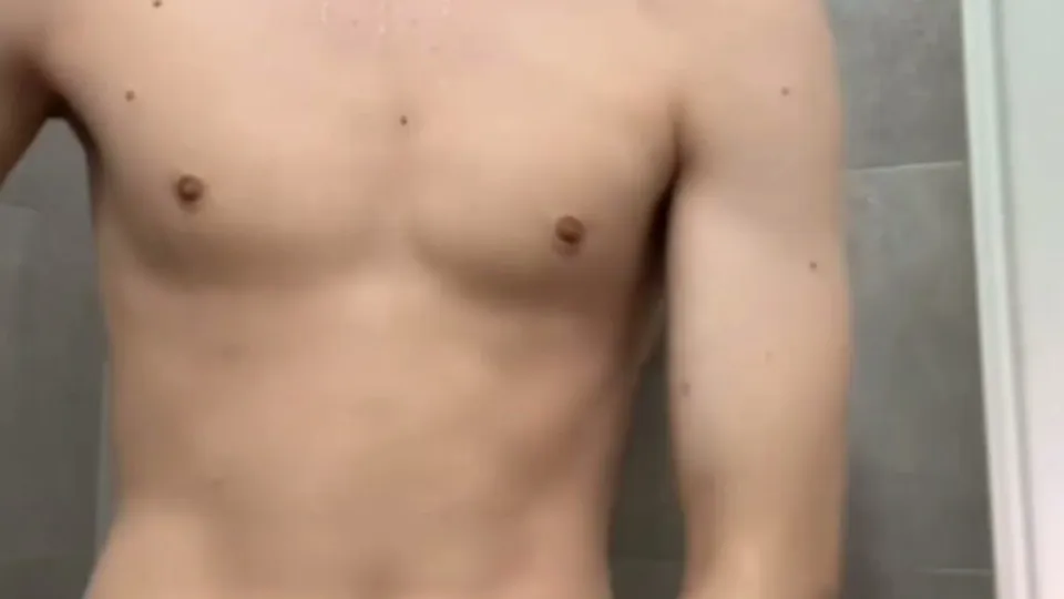 young man showers, flexing toned torso