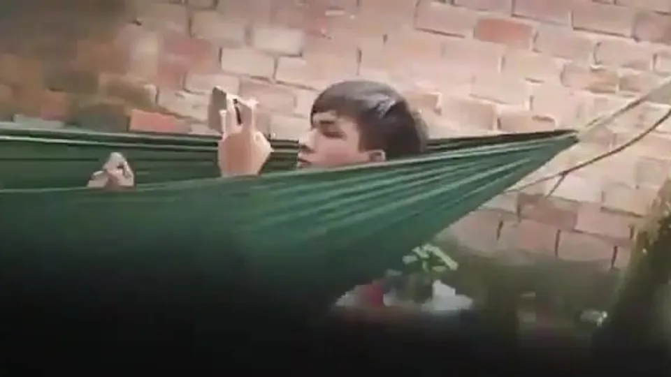 Guy caught jerking-off in a hammock outside.