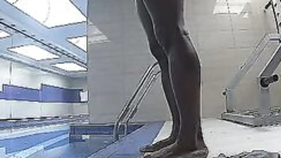 Handsome guy naked in a hotel pool.