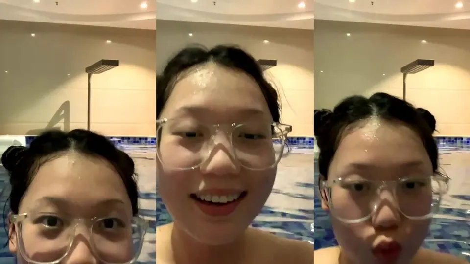 Hot girl with big breasts and glasses swims naked in the hotel pool  