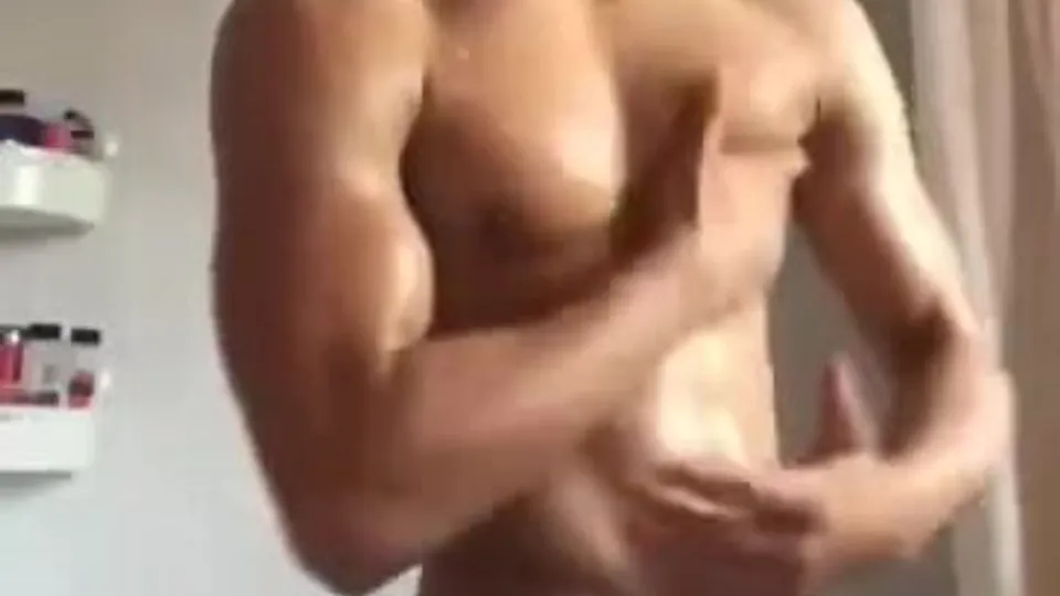 Latino muscle boy flexes and strips