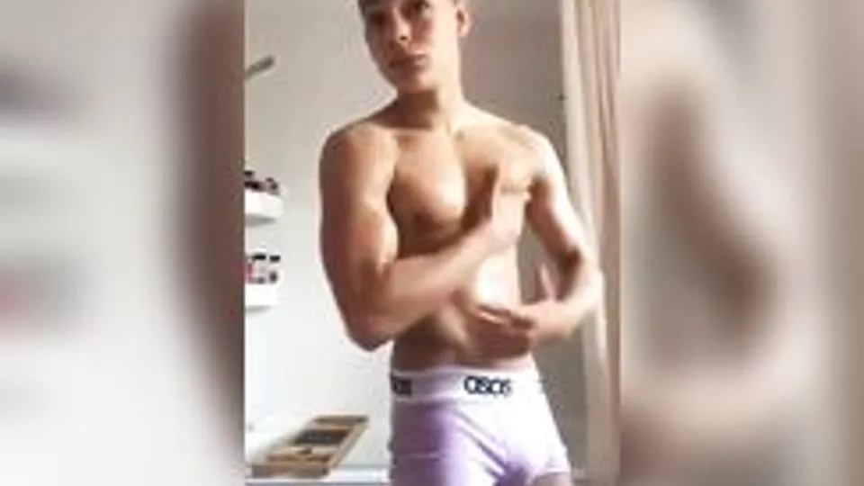 Latino muscle boy flexes and strips