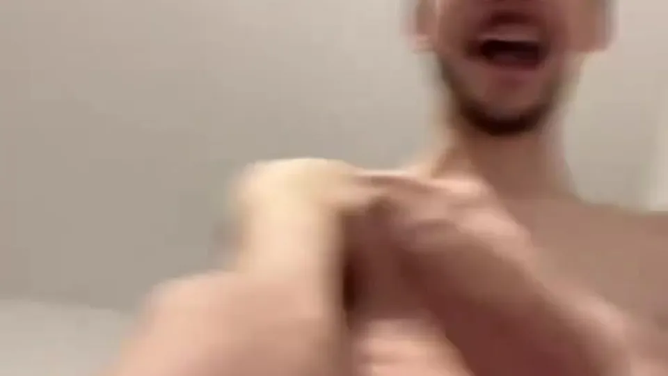 Shirtless dude laughs while another touches his chest