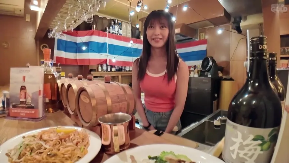 Asian Barmaid in Red Tank Top Serves Drinks