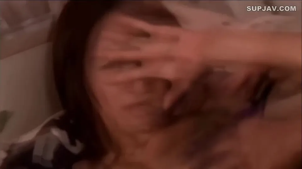 Dark-haired woman in black and white top, intimate moment