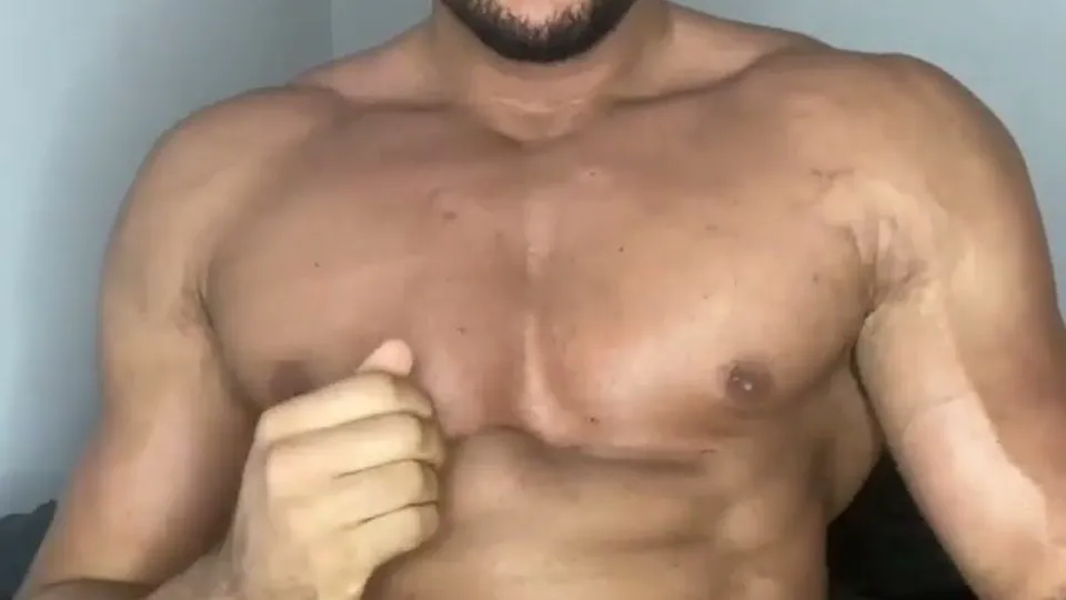 Muscular man flexes and teases shirtless