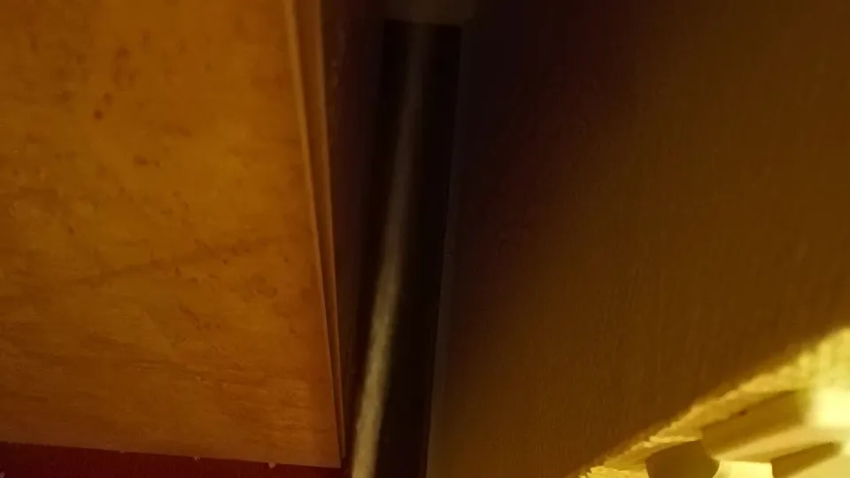 Two men fuck in dimly lit room