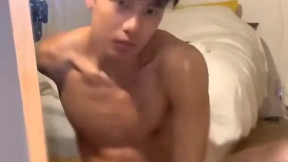 Pretty faced asian boy rides his toy