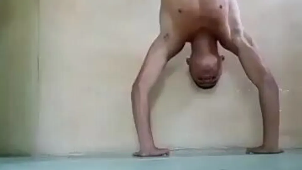 Muscular Latino Performer in Intense Handstand and Push-Up Display