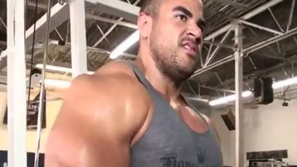 Sexy sweaty bodybuilder flexing biceps with hairy armpits