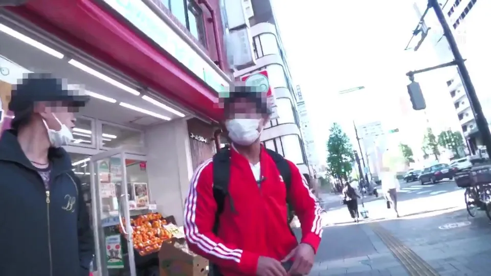 Two guys in red and black jackets walk city streets