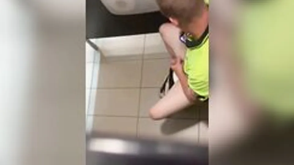 Spying on a guy in a yellow T-shirt jerking off in the toilet