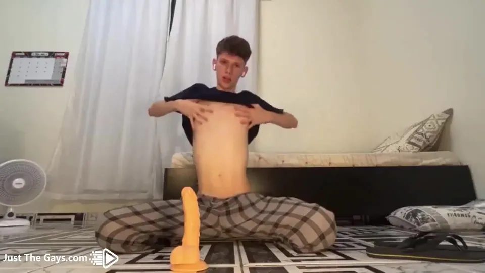 Twink rides a dildo while he jerks his big cock